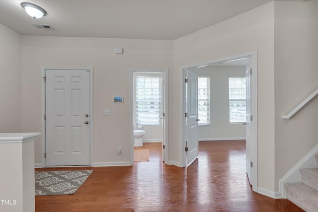 130 Holly Berry Ln, Durham, NC 27703 - entrance foyer with stairway and wood finished floors