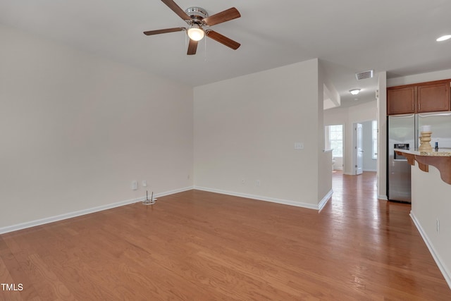 130 Holly Berry Ln, Durham, NC 27703 - unfurnished living room with a ceiling fan and light wood finished floors