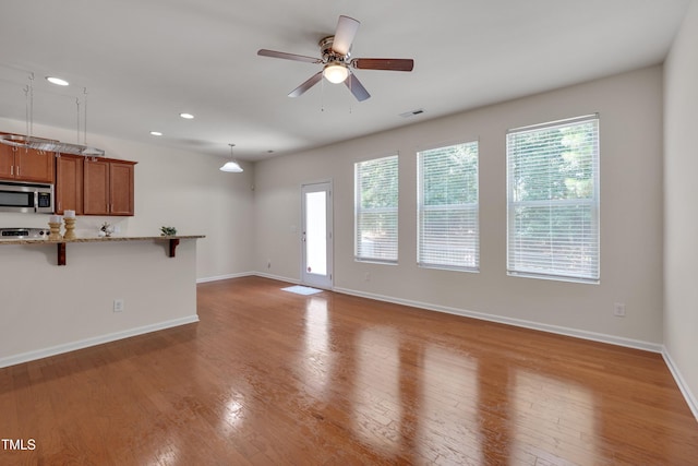 130 Holly Berry Ln, Durham, NC 27703 - unfurnished living room with wood finished floors, a ceiling fan, and recessed lighting
