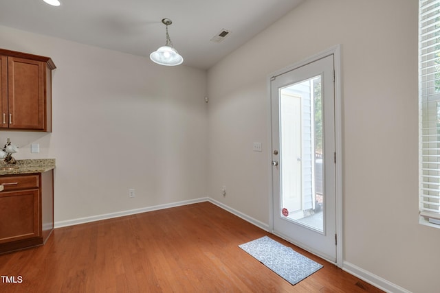 130 Holly Berry Ln, Durham, NC 27703 - unfurnished dining area featuring light wood finished floors and plenty of natural light