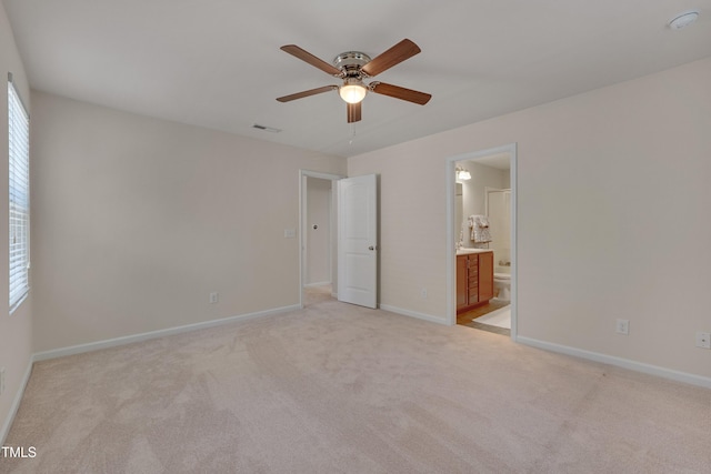 130 Holly Berry Ln, Durham, NC 27703 - unfurnished bedroom with light colored carpet, ensuite bathroom, and ceiling fan