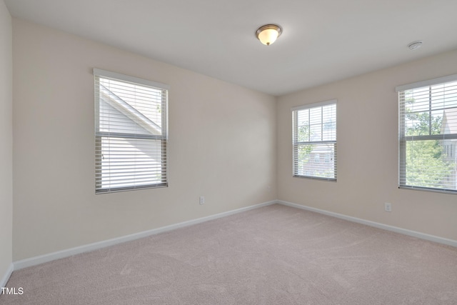 130 Holly Berry Ln, Durham, NC 27703 - empty room featuring light carpet and a smoke detector