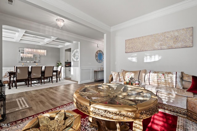 27 Needham Ln, Clayton, NC 27527 - living room featuring a chandelier, coffered ceiling, wood finished floors, a decorative wall, and ornamental molding