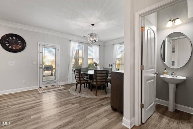 27 Needham Ln, Clayton, NC 27527 - dining room with wood finished floors, ornamental molding, plenty of natural light, and a chandelier