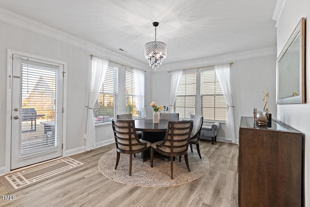 27 Needham Ln, Clayton, NC 27527 - dining space featuring a chandelier, crown molding, and light wood-type flooring