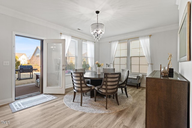 27 Needham Ln, Clayton, NC 27527 - dining space with ornamental molding, a chandelier, and light wood finished floors