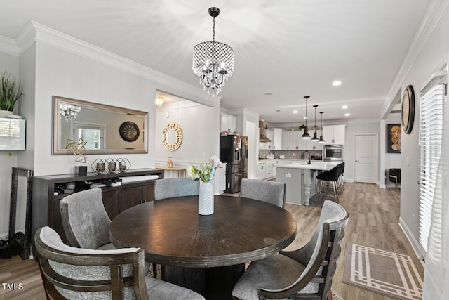 27 Needham Ln, Clayton, NC 27527 - dining area featuring light wood-style flooring, healthy amount of natural light, a chandelier, crown molding, and recessed lighting