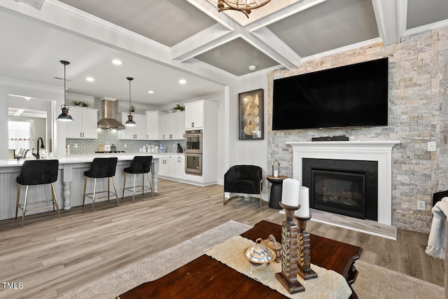 27 Needham Ln, Clayton, NC 27527 - living area with light wood-type flooring, ornamental molding, a glass covered fireplace, beamed ceiling, and recessed lighting