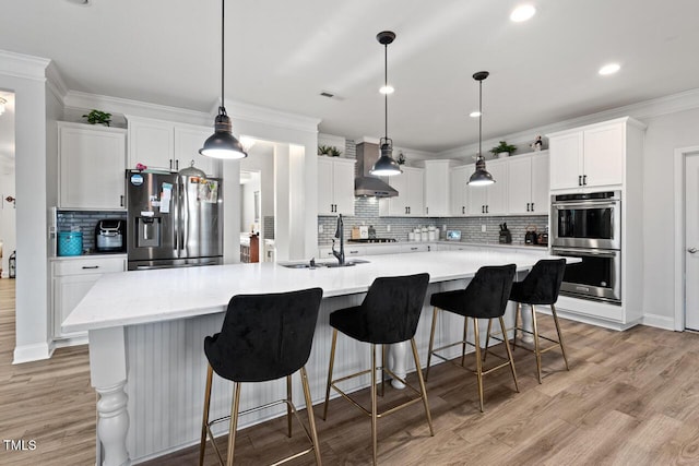 27 Needham Ln, Clayton, NC 27527 - kitchen featuring appliances with stainless steel finishes, decorative backsplash, ornamental molding, white cabinetry, and light countertops