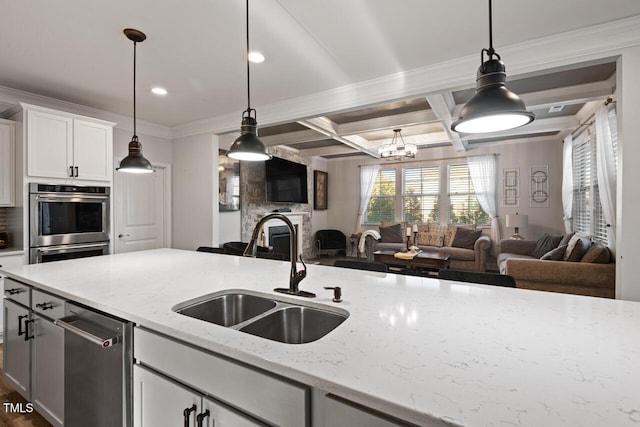 27 Needham Ln, Clayton, NC 27527 - kitchen featuring open floor plan, stainless steel appliances, light stone countertops, white cabinetry, and coffered ceiling