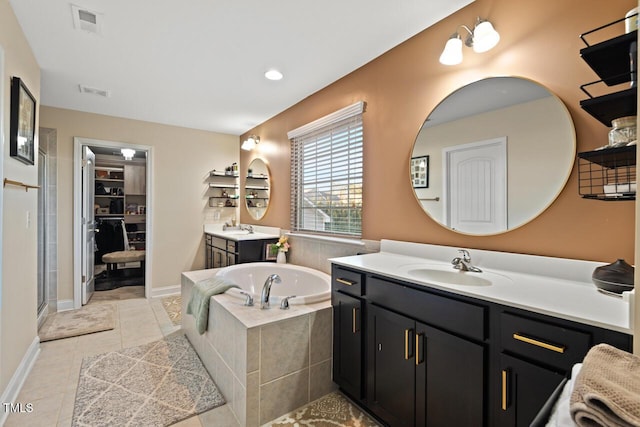 27 Needham Ln, Clayton, NC 27527 - full bathroom featuring a bath, two vanities, a stall shower, a spacious closet, and tile patterned floors