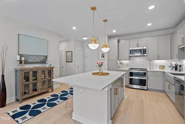 105 Chatham Walk Ln Unit 208, Cary, NC 27511 - kitchen featuring stainless steel appliances, gray cabinets, light wood-type flooring, a center island, and recessed lighting
