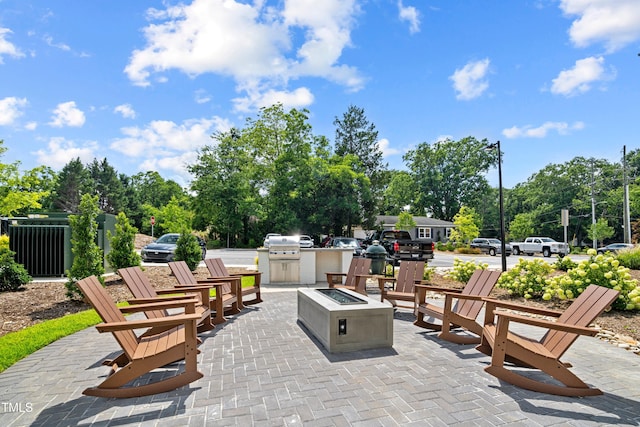 105 Chatham Walk Ln Unit 208, Cary, NC 27511 - view of patio featuring a fire pit, area for grilling, and view of wooded area