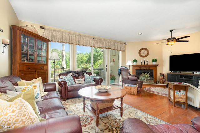 7 Weybridge Pl, Chapel Hill, NC 27517 - living area with hardwood / wood-style flooring, a ceiling fan, and a fireplace with raised hearth