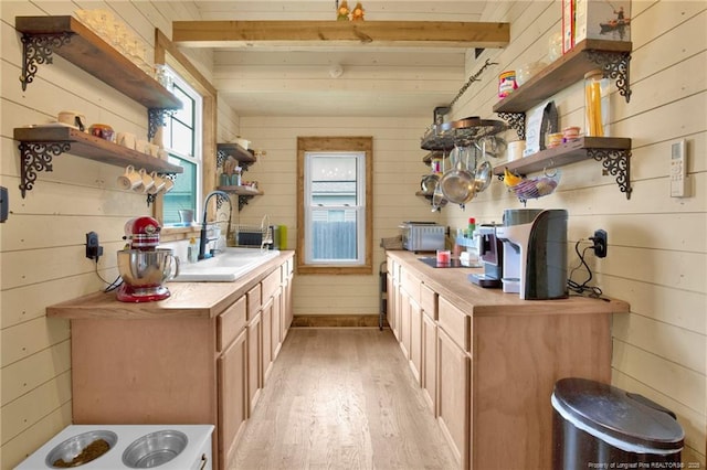 1203 Simpson St, Fayetteville, NC 28305 - kitchen with open shelves, light wood finished floors, wooden walls, and light countertops