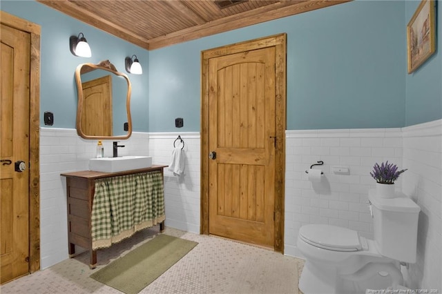1203 Simpson St, Fayetteville, NC 28305 - half bath featuring wooden ceiling, wainscoting, tile walls, and vanity