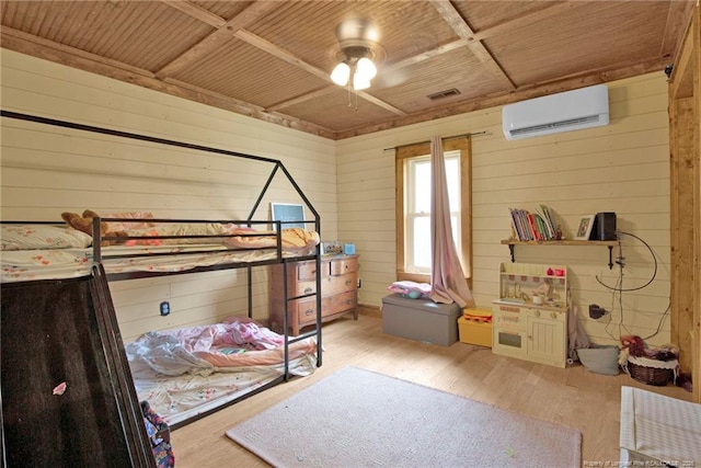 1203 Simpson St, Fayetteville, NC 28305 - bedroom featuring a wall unit AC, wood walls, and wood finished floors