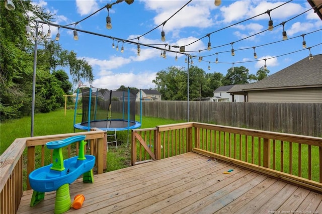 1203 Simpson St, Fayetteville, NC 28305 - wooden terrace featuring a trampoline and a fenced backyard