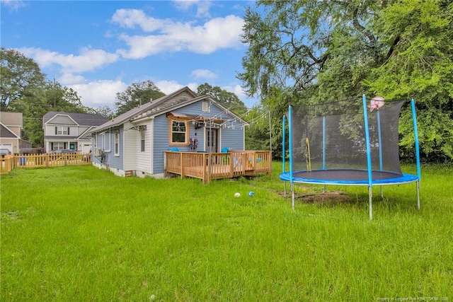 1203 Simpson St, Fayetteville, NC 28305 - rear view of property with a trampoline and a wooden deck