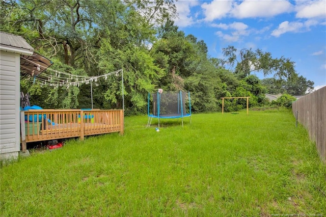1203 Simpson St, Fayetteville, NC 28305 - view of yard with a trampoline and a wooden deck