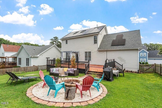 2301 Laurel Valley Way, Raleigh, NC 27604 - rear view of house featuring a wooden deck, solar panels, a fenced backyard, roof with shingles, and an outdoor living space with a fire pit