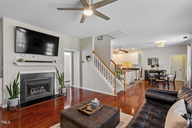2301 Laurel Valley Way, Raleigh, NC 27604 - living area featuring ceiling fan, stairway, wood finished floors, and a fireplace