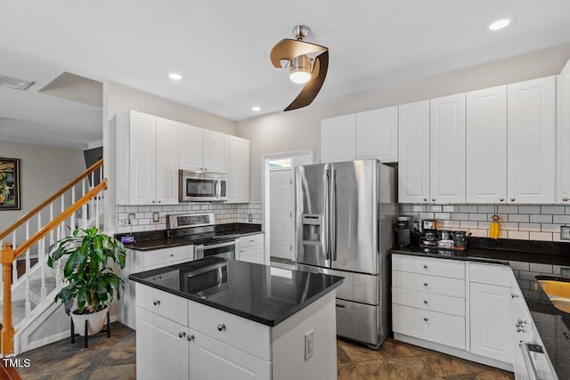 2301 Laurel Valley Way, Raleigh, NC 27604 - kitchen with appliances with stainless steel finishes, backsplash, a center island, white cabinets, and recessed lighting