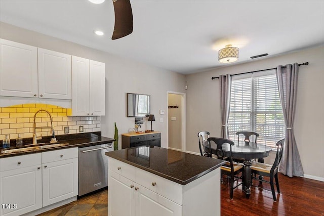 2301 Laurel Valley Way, Raleigh, NC 27604 - kitchen featuring dark countertops, dishwasher, tasteful backsplash, white cabinets, and a center island