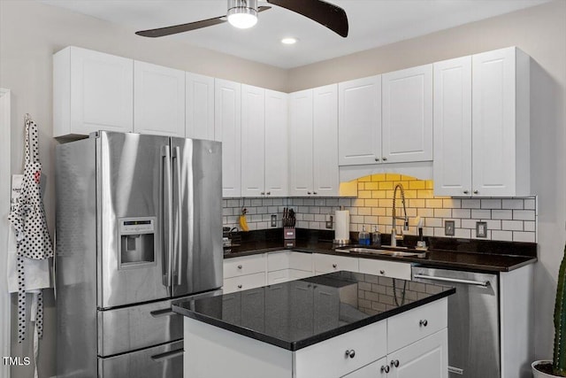 2301 Laurel Valley Way, Raleigh, NC 27604 - kitchen featuring appliances with stainless steel finishes, a ceiling fan, white cabinetry, dark countertops, and backsplash