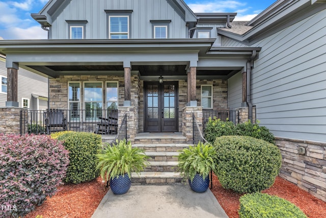 3329 Donlin Dr, Wake Forest, NC 27587 - entrance to property with a porch, french doors, board and batten siding, and stone siding