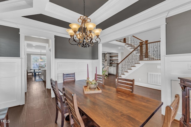 3329 Donlin Dr, Wake Forest, NC 27587 - dining room with a chandelier, a decorative wall, ornamental molding, stairs, and dark wood-type flooring