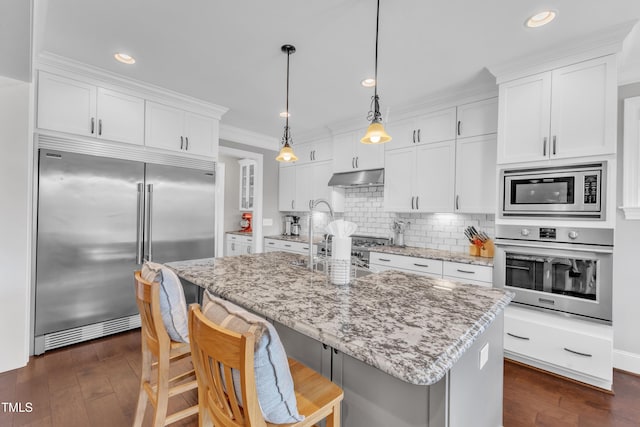 3329 Donlin Dr, Wake Forest, NC 27587 - kitchen featuring built in appliances, white cabinets, dark wood-type flooring, tasteful backsplash, and crown molding