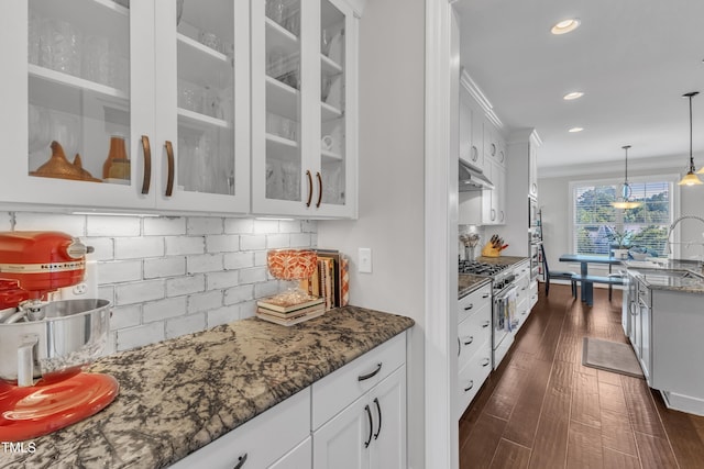 3329 Donlin Dr, Wake Forest, NC 27587 - kitchen with glass insert cabinets, dark stone countertops, white cabinets, dark wood-type flooring, and stainless steel stove