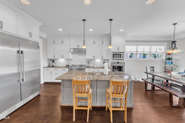3329 Donlin Dr, Wake Forest, NC 27587 - kitchen featuring built in appliances, tasteful backsplash, white cabinetry, crown molding, and light stone countertops