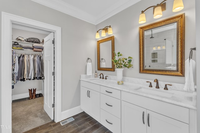 3329 Donlin Dr, Wake Forest, NC 27587 - full bathroom with double vanity, ornamental molding, a tile shower, a walk in closet, and wood finished floors