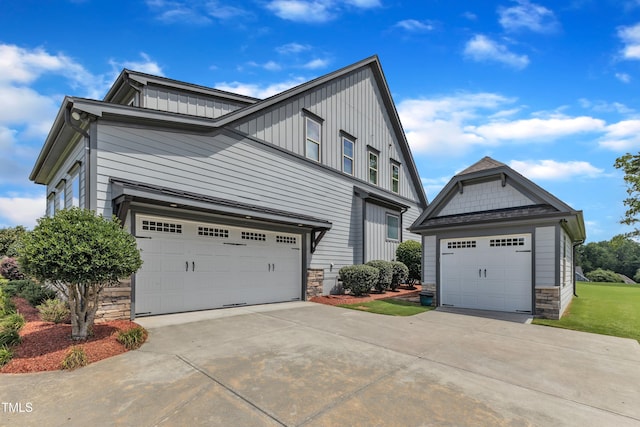 3329 Donlin Dr, Wake Forest, NC 27587 - view of home's exterior with stone siding, board and batten siding, and driveway