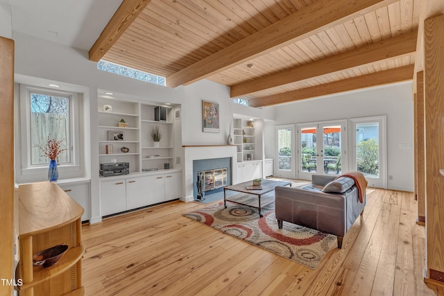 206 Spring Ln, Chapel Hill, NC 27514 - living room featuring french doors, light wood finished floors, a fireplace with flush hearth, a wood ceiling with exposed beams, and built in features
