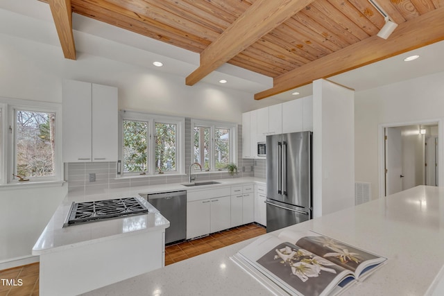 206 Spring Ln, Chapel Hill, NC 27514 - kitchen featuring healthy amount of natural light, stainless steel appliances, backsplash, a wooden ceiling with exposed beams, and recessed lighting