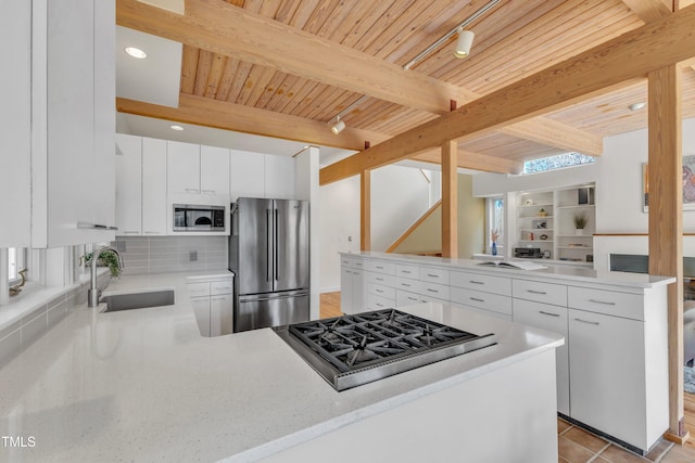 206 Spring Ln, Chapel Hill, NC 27514 - kitchen with a peninsula, stainless steel appliances, tasteful backsplash, a wood ceiling with exposed beams, and white cabinetry
