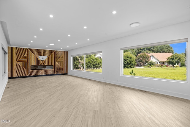 115 Ashworth Dr, Durham, NC 27707 - unfurnished living room with light wood-type flooring, recessed lighting, and a glass covered fireplace