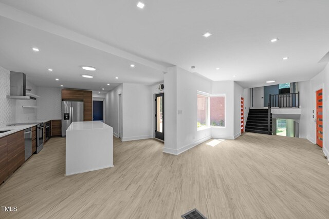 115 Ashworth Dr, Durham, NC 27707 - kitchen featuring stainless steel appliances, wall chimney exhaust hood, open floor plan, modern cabinets, and light countertops
