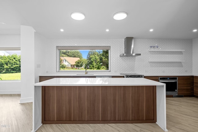 115 Ashworth Dr, Durham, NC 27707 - kitchen with wall chimney exhaust hood, stainless steel oven, open shelves, a center island, and light countertops