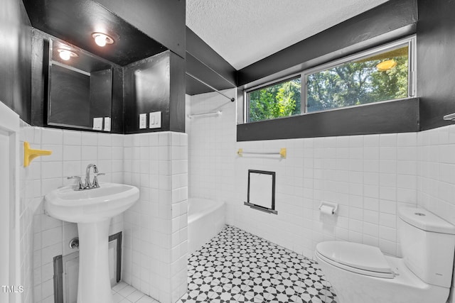 115 Ashworth Dr, Durham, NC 27707 - full bathroom featuring tile walls, tub / shower combination, a wainscoted wall, tile patterned floors, and a textured ceiling