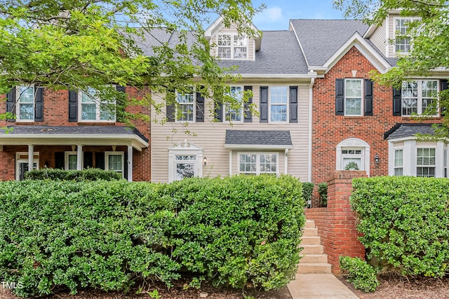 2738 Garden Knoll Ln, Raleigh, NC 27614 - colonial inspired home with roof with shingles and brick siding