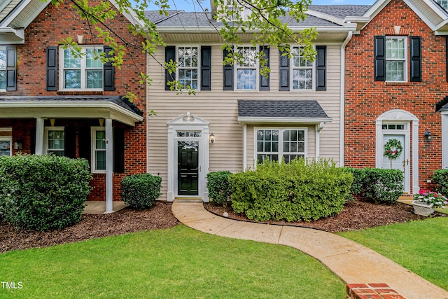 2738 Garden Knoll Ln, Raleigh, NC 27614 - colonial house with roof with shingles, a front yard, and brick siding