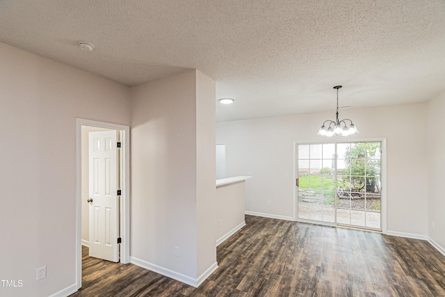 2738 Garden Knoll Ln, Raleigh, NC 27614 - empty room featuring dark wood finished floors, a chandelier, and a textured ceiling