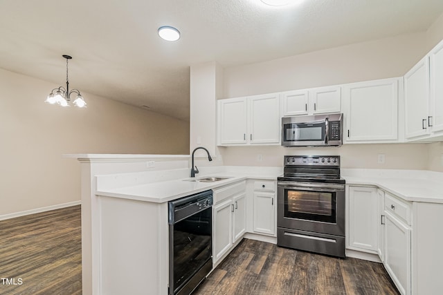 2738 Garden Knoll Ln, Raleigh, NC 27614 - kitchen with appliances with stainless steel finishes, a peninsula, dark wood finished floors, and white cabinetry