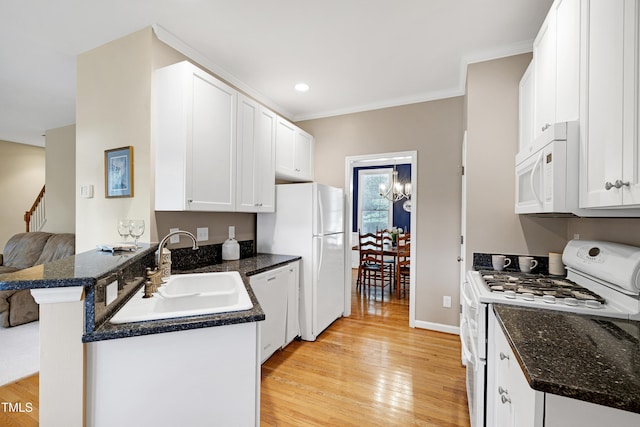 102 Whitlock Ln, Cary, NC 27513 - kitchen with white appliances, light wood finished floors, white cabinets, ornamental molding, and dark stone counters
