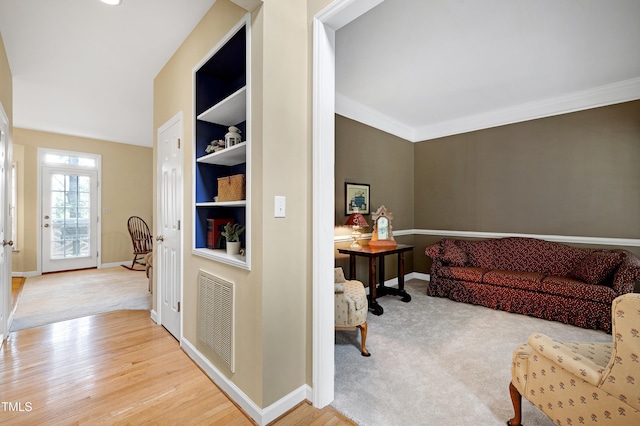 102 Whitlock Ln, Cary, NC 27513 - living room with ornamental molding, built in features, carpet floors, and wood finished floors