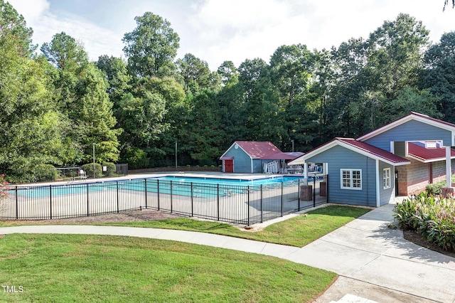 102 Whitlock Ln, Cary, NC 27513 - community pool featuring an outbuilding and view of wooded area